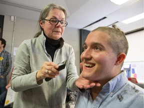 Carleton University student Josh Nadler gets his head shaved as part of World Cancer Day,