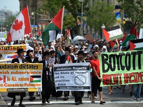 People take part in a protest and march in Ottawa on Tuesday July 22, 2014, calling for Canada to defend human rights in Palestine. THE CANADIAN PRESS/Sean Kilpatrick