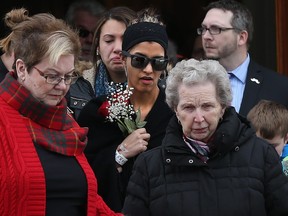 Family and friends gathered to attend the funeral of Bernard Cameron at the Holy Name of Mary Parish Church in Almonte on Friday. Bernard's daughter Sarah - holding flowers - attended the funeral.