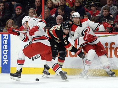 Ottawa Senators' Bobby Ryan (6) fights for the puck against Carolina Hurricanes' Riley Nash (20) and Jaccob Slavin (74) during second period NHL action.