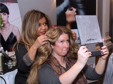 Brea Wilkins checks out the results after getting her hair spruced up by a Rinaldo stylist during the Revive Your Style fundraiser for breast health, held Sunday, January 31, 2016 at the Sala San Marco banquet hall.