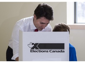 Liberal leader Justin Trudeau carries his vote to the ballot box accompanied by his son Xavier on October 19, 2015 in Montreal. The youth vote was robust in the election.