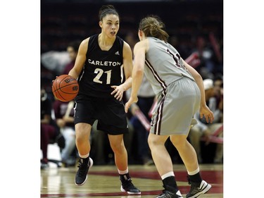 Carleton University Ravens' Elizabeth Leblanc, left, carries the ball up court while guarded by uOttawa Gee-Gees' Kellie Ring.