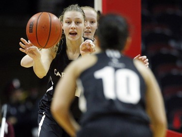 Carleton University Ravens' Lindsey passes the ball to teammate, Abeer Farhat, 10.