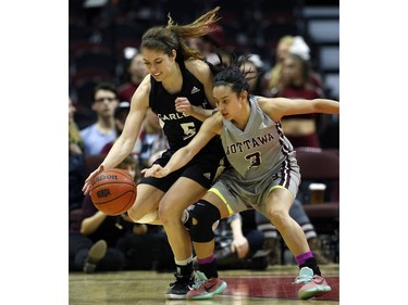 Carleton University Ravens' Stephanie Carr, left, battles for the ball with uOttawa Gee-Gees' Julia Soriano.