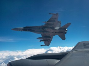 A Royal Canadian Air Force CF-18 Hornet breaks away after refuelling with a KC-135 Stratotanker assigned to the 340th Expeditionary Air Refueling Squadron on Oct. 30, 2014 over Iraq.