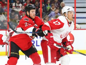 Chris Neil of the Ottawa Senators gives Brad Richards of the Detroit Red Wings a shot in the back during the first period.