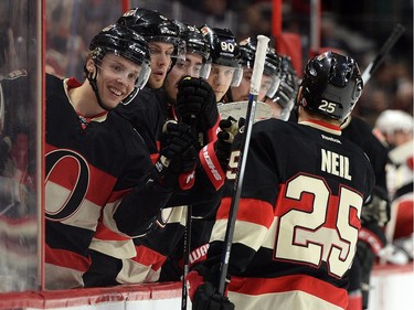 Ottawa Senators' Chris Neil gets high-fives from his teammates after an assist on a goal by Senators' Zack Smith, not shown, during second period NHL action.