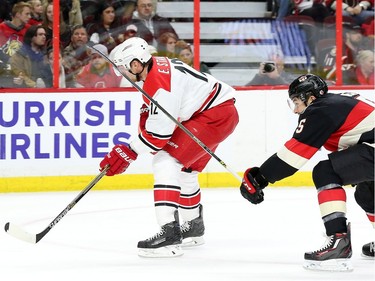 Cody Ceci of the Ottawa Senators gets a high sticking penalty as his stick hits Eric Staal of the Carolina Hurricanes in the face during second period NHL action.