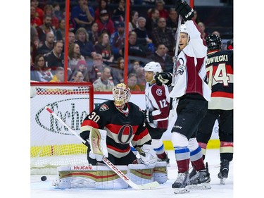 Colorado Avalanche center Mikhail Grigorenko (25) celebrates a goal as Ottawa Senators goalie Andrew Hammond (30) looks on.