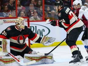 Colorado Avalanche right wing Jarome Iginla (not seen) scores on Ottawa Senators goalie Andrew Hammond (30) as Senators Mark Borowiecki (74) and Colorado Avalanche center Matt Duchene (9) watch the play.