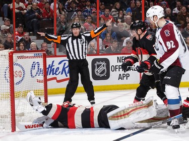 Andrew Hammond #30 of the Ottawa Senators makes a desperate save as Gabriel Landeskog #92 of the Colorado Avalanche and Dion Phaneuf #2 of the Ottawa Senators look on.