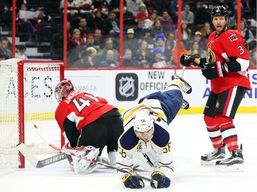 Craig Anderson, left, and Marc Methot of the Ottawa Senators defend against Josh Bailey of the Buffalo Sabres during second period NHL action.