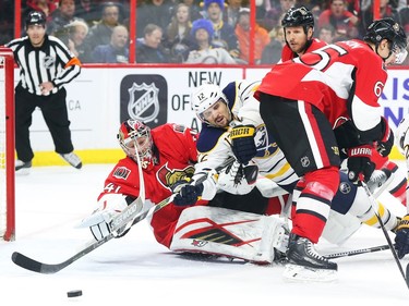 Craig Anderson of the Ottawa Senators follows the puck as Brian Gionta of the Buffalo Sabres tries to score during second period NHL action.