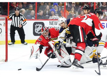 Craig Anderson of the Ottawa Senators follows the puck as Brian Gionta of the Buffalo Sabres tries to score during second period NHL action.