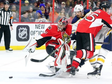 Craig Anderson of the Ottawa Senators follows the puck as Brian Gionta of the Buffalo Sabres tries to score during second period NHL action.