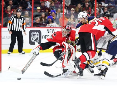 Craig Anderson of the Ottawa Senators follows the puck as Brian Gionta of the Buffalo Sabres tries to score during second period NHL action.