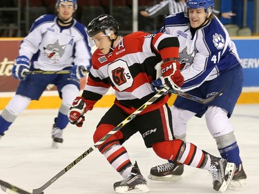 Dante Salituro skates past Mikkel Aagaard, right.