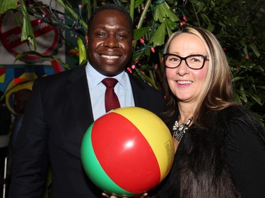 Derek Nzeribe, from presenting sponsor ArtHaus condominiums by DevMcGill, with Downtown Rideau BIA executive director Peggy DuCharme at On the Rocks: In the Caribbean, an annual Winterlude party hosted by the Ottawa Art Gallery and held at City Hall on Friday, February 5, 2016. (Caroline Phillips / Ottawa Citizen)