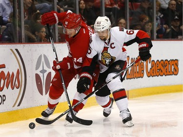 Detroit Red Wings center Gustav Nyquist (14) and Ottawa Senators defenseman Erik Karlsson (65) battle for the puck in the second period.