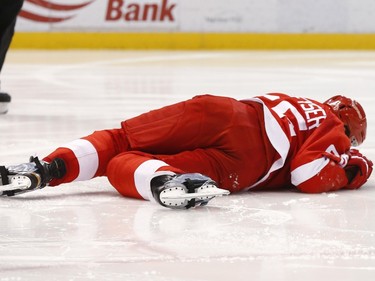 Detroit Red Wings defenseman Danny DeKeyser (65) lies on the ice after being hit by a Ottawa Senators shot in the third period.