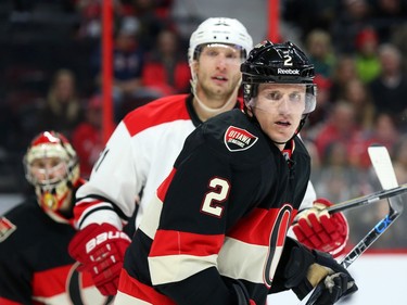 Dion Phaneuf (2) of the Ottawa Senators battles against Jordan Staal of the Carolina Hurricanes during second period NHL action.