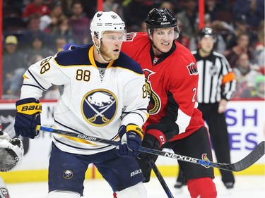 Dion Phaneuf of the Ottawa Senators battles against Jamie McGinn of the Buffalo Sabres during second period NHL action.