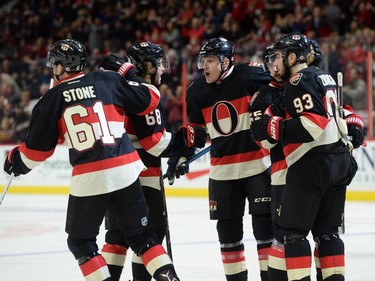Ottawa Senators' Dion Phaneuf, middle, celebrates with teammates after they scored against the Colorado Avalanche during second period NHL action.