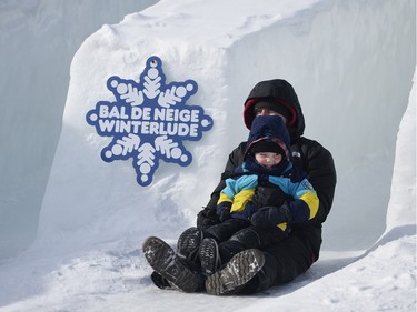 Duff Wray and his son Hank (5) enjoy the slide ride down the hill at Jacques Cartier park during the last weekend of Winterlude on Saturday Feb. 13, 2016.