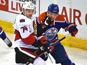 Edmonton Oilers Mark Letestu (55) and Ottawa Senators Mark Borowiecki (74) battle in front of the Senators net.