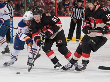 Mark Stone #61 of the Ottawa Senators drives the puck over the blue line against Teddy Purcell #16 of the Edmonton Oilers.