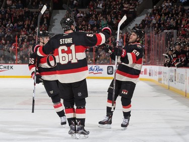 Mike Hoffman #68 of the Ottawa Senators celebrates his first period goal against the Edmonton Oilers with teammates Erik Karlsson #65 and Mark Stone #61.