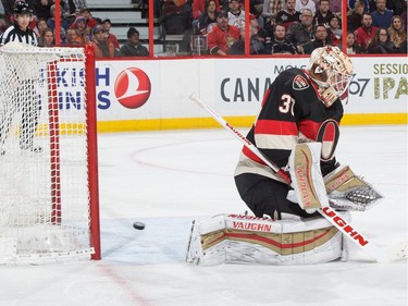 The puck gets behind Andrew Hammond #30 of the Ottawa Senators for a second period goal by Zack Kassian of the Edmonton Oilers.