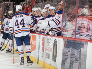 Zack Kassian #44 of the Edmonton Oilers celebrates his second period goal against the Ottawa Senators with teammates at the players bench.