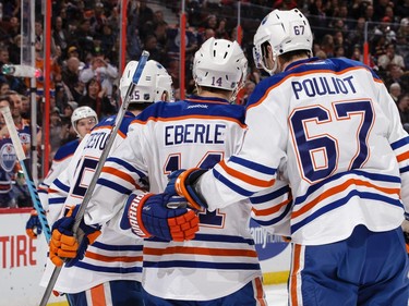 Jordan Eberle #14 of the Edmonton Oilers celebrates his first-period power-play goal against the Ottawa Senators with teammates Benoit Pouliot #67 and Mark Letestu #55.