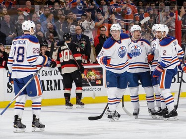 Mark Fayne #5 of the Edmonton Oilers celebrates his first-period goal against the Ottawa Senators with teammates Matt Hendricks #23, Andrej Sekera #2 and Lauri Korpikoski #28.