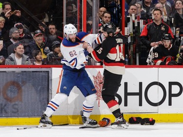 Zack Smith #15 of the Ottawa Senators fights former teammate Eric Gryba #62 of the Edmonton Oilers.