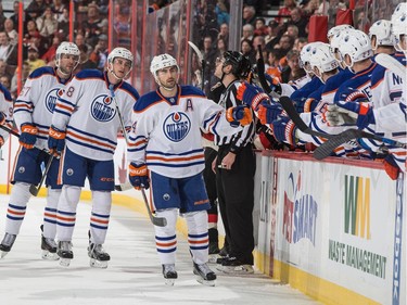 Jordan Eberle #14 of the Edmonton Oilers celebrates his first of two first period goals with teammates at the players bench.