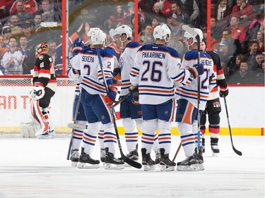 Andrej Sekera #2, Iiro Pakarinen #26 and Matt Hendricks #23 of the Edmonton Oilers celebrate the first of three first period goals.