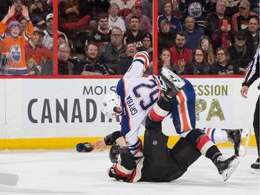 Eric Gryba #62 of the Edmonton Oilers throws Max McCormick #89 of the Ottawa Senators to the ice during a first period fight.