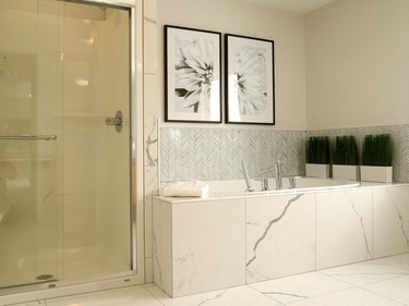 Marble tile laid in a herringbone pattern and soft tones add to the spa-like feel in the master ensuite.