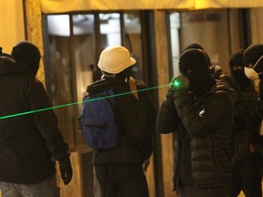 A protester holds a laser pointer during a protest earlier this month in Corsica.