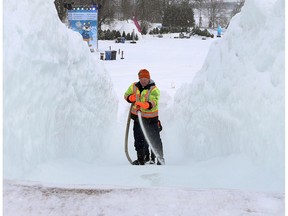 Kevin Matthews from Meykaecht-Lischer waters down the ice slides at Jacques Cartier Park in Gatineau Wednesday, gearing up for the final weekend of Winterlude.