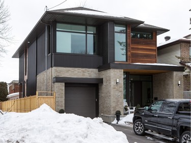 Comprising ipe wood, corrugated metal, and rough-cut brick, the front elevation is an intriguing blend of push-and-pull design that draws your eye to the home. The front entrance is clearly identified, sheltered from the weather and includes a street-friendly sitting area for summer. Thanks to its colour and the overhang above it, the garage door is barely noticeable.