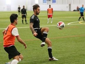 James Bailey (in black) of the Ottawa Fury FC kicks the ball during a scrimmage during training camp in Gatineau.