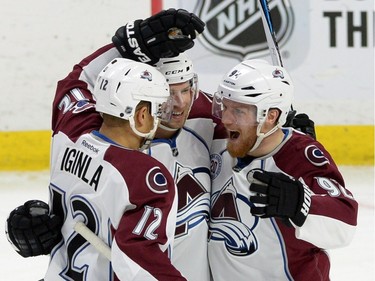 Colorado Avalanche's Jarome Iginla, left celebrates his first period goal with teammates Blake Comeau, middle, and Gabriel Landeskog.