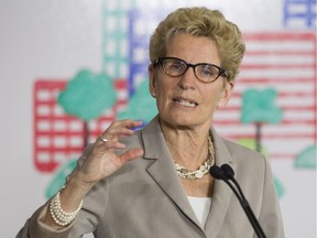 Ontario Premier Kathleen Wynne addresses the media during an announcement which outlined a cap and trade deal with Quebec aimed at curbing green house emissions, in Toronto on Monday, April 13 2015.