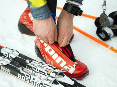 Kieran Jones finished first in the 27km Classique race at the Gatineau Loppet Saturday February 27, 2016. Jones takes his timing chip of his ski boot.