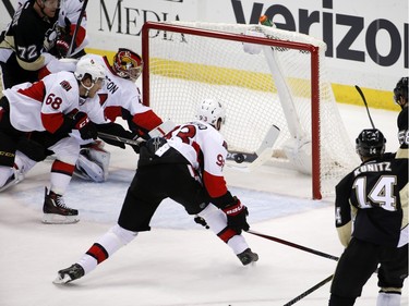 Pittsburgh Penguins' Kris Letang (58) backhands a rebound past Ottawa Senators goalie Craig Anderson (41) for a goal during the first period.