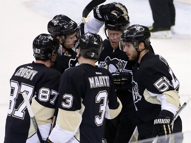Pittsburgh Penguins' Kris Letang (58) celebrates his goal with teammates during the first period.